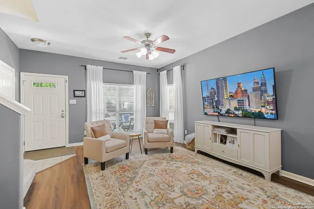 a living room with furniture a fireplace and a flat screen tv