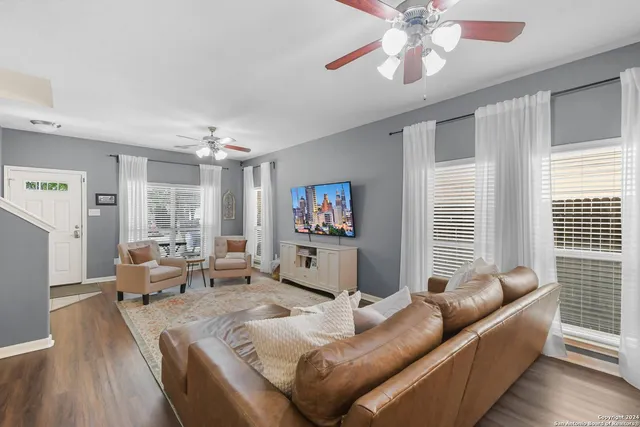 a living room with furniture and a large window