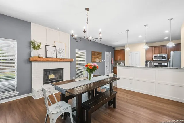 a living room with furniture a fireplace and kitchen view