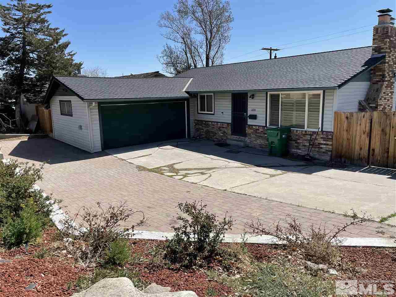 1690 Carlin Street Reno, NV 89503 - Photo 1 of 31 a front view of a house with a yard and garage