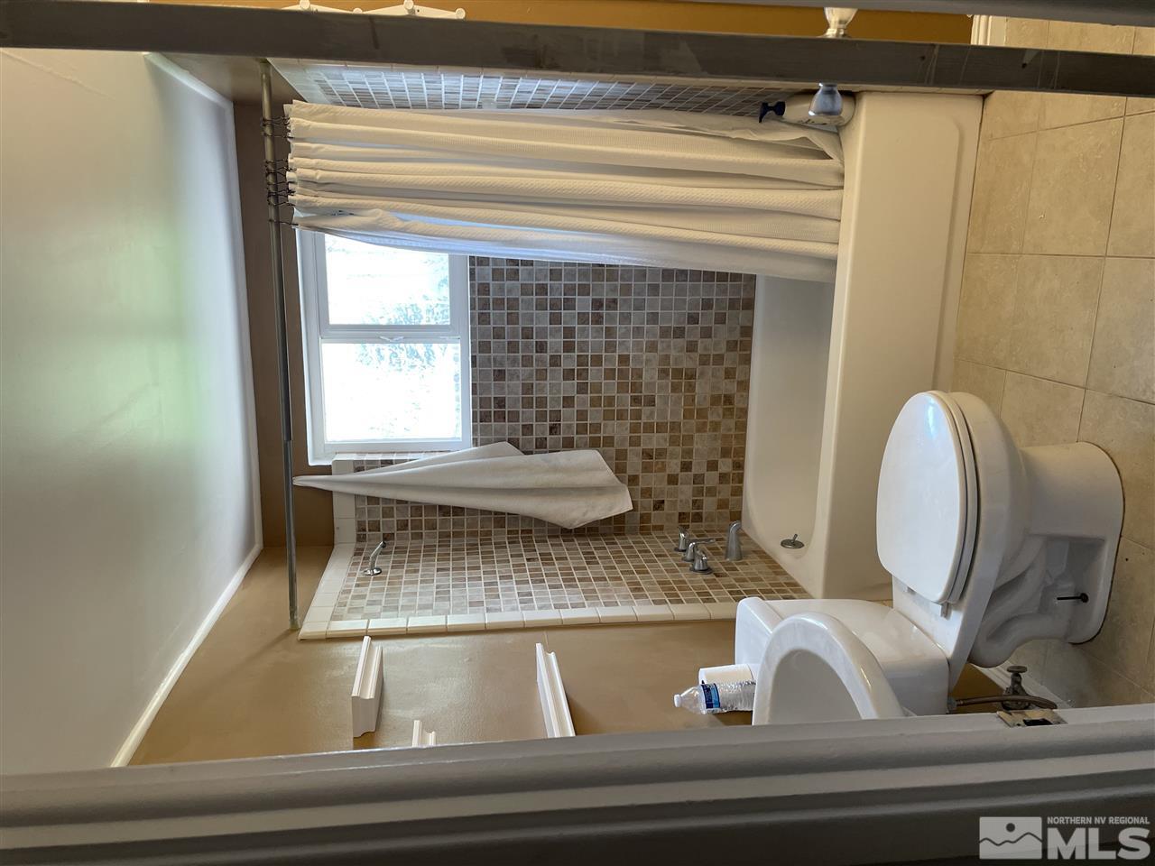 1690 Carlin Street Reno, NV 89503 - Photo 17 of 31 a bathroom with a toilet and a bathtub