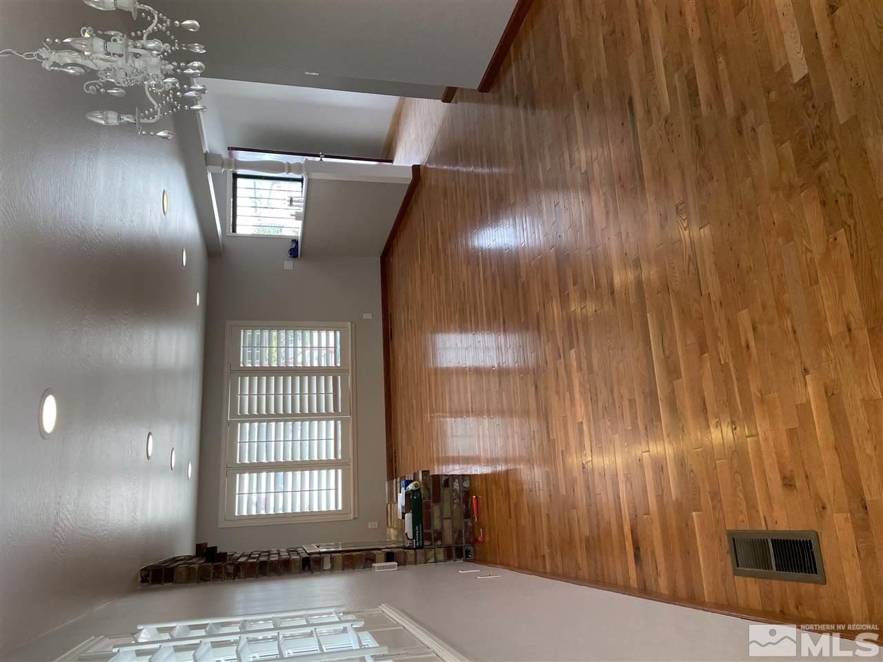 1690 Carlin Street Reno, NV 89503 - Photo 3 of 31 an empty room with wooden floor and windows