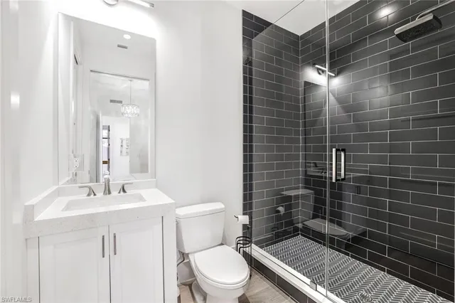 a bathroom with a toilet sink and shower