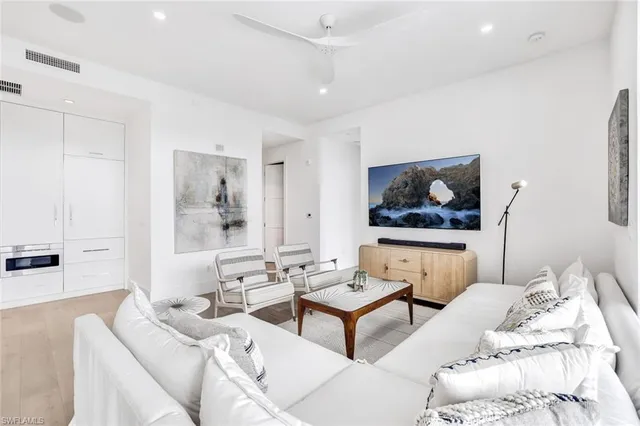 a living room with furniture and a painting