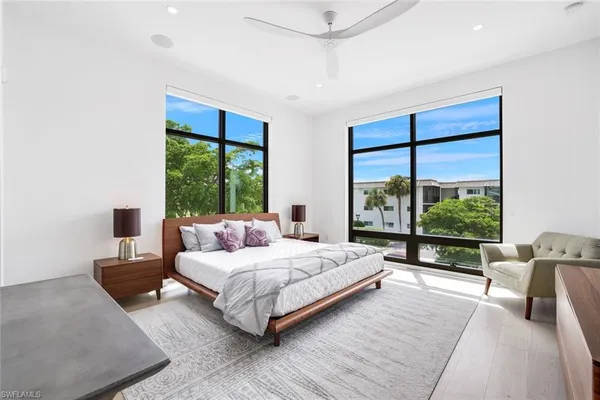 a bedroom with a large bed and a large window