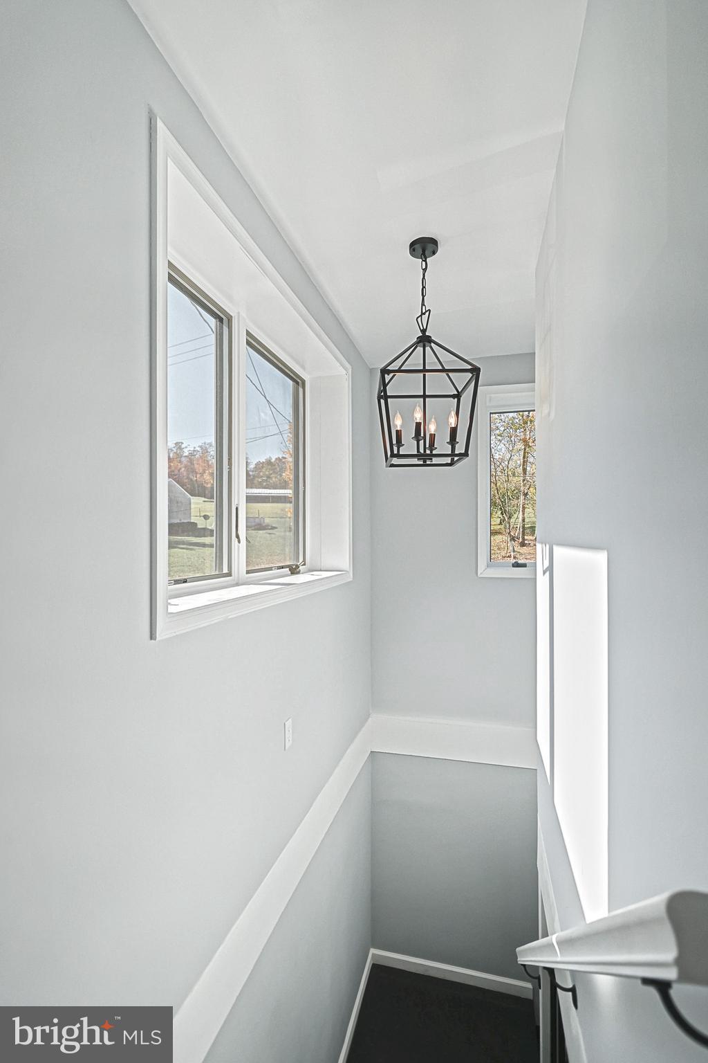1734 Hametown Road Glen Rock, PA 17327 - Photo 30 of 40 Well lit stairway with chandelier and windows.