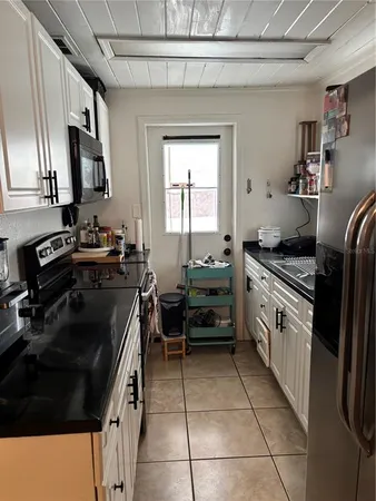 a kitchen with a stove a sink and a refrigerator