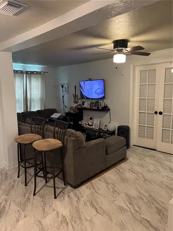a living room with furniture and a wooden floor