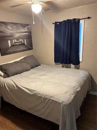 a bedroom with a bed and a mirror