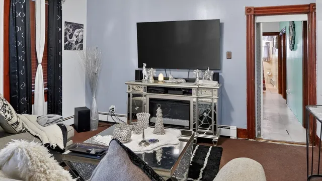 a living room with furniture and a flat screen tv