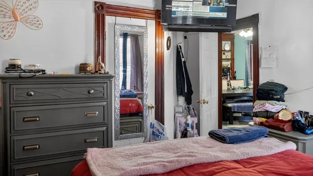 a bedroom with a bed and a closet