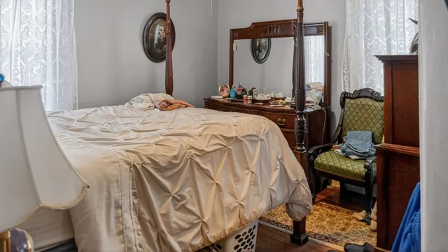 a bedroom with bed and a mirror