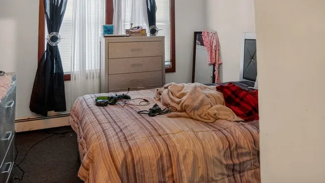 a bedroom with a bed and a mirror