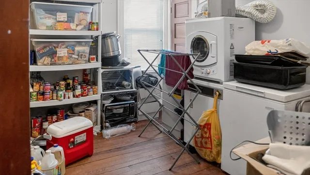 a utility room with dryer washer and shoe rack