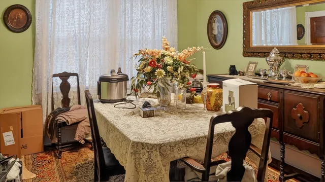 a view of a dining room with furniture and chandelier