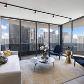 a living room with furniture and floor to ceiling windows