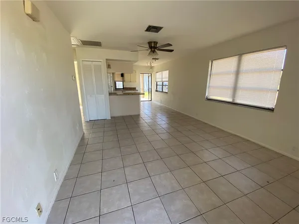 a view of an empty room and wooden floor
