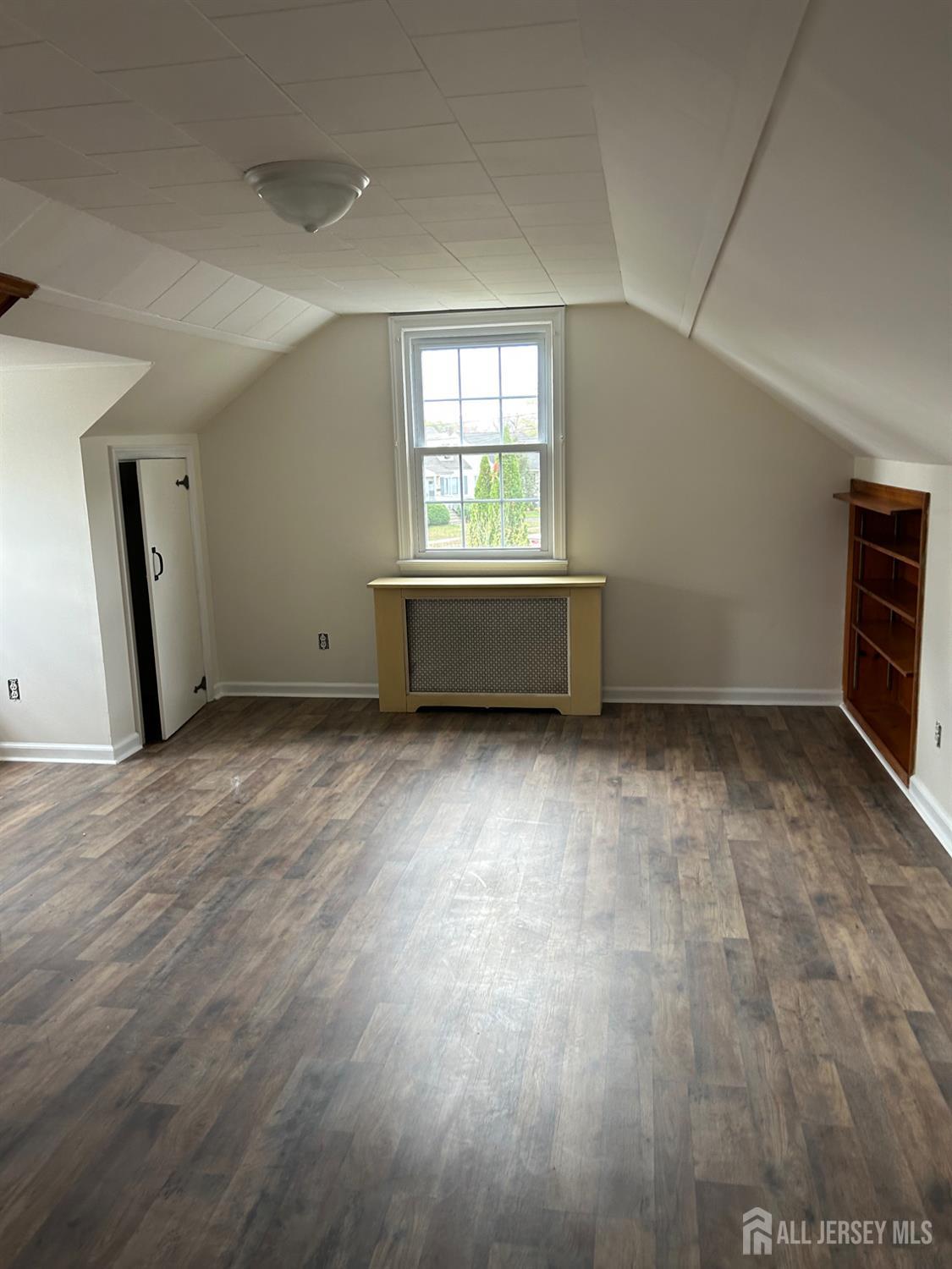 518 2nd Street Dunellen, NJ 08812 - Photo 12 of 14 an empty room with wooden floor and windows