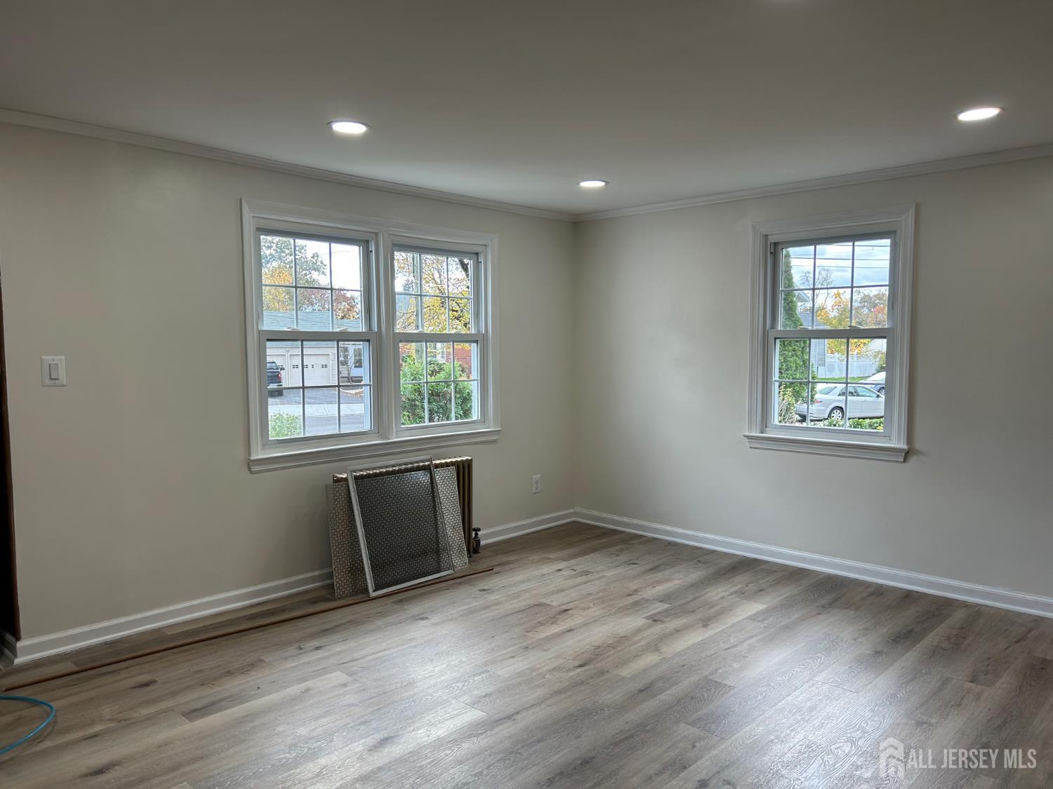 518 2nd Street Dunellen, NJ 08812 - Photo 2 of 14 an empty room with wooden floor and windows