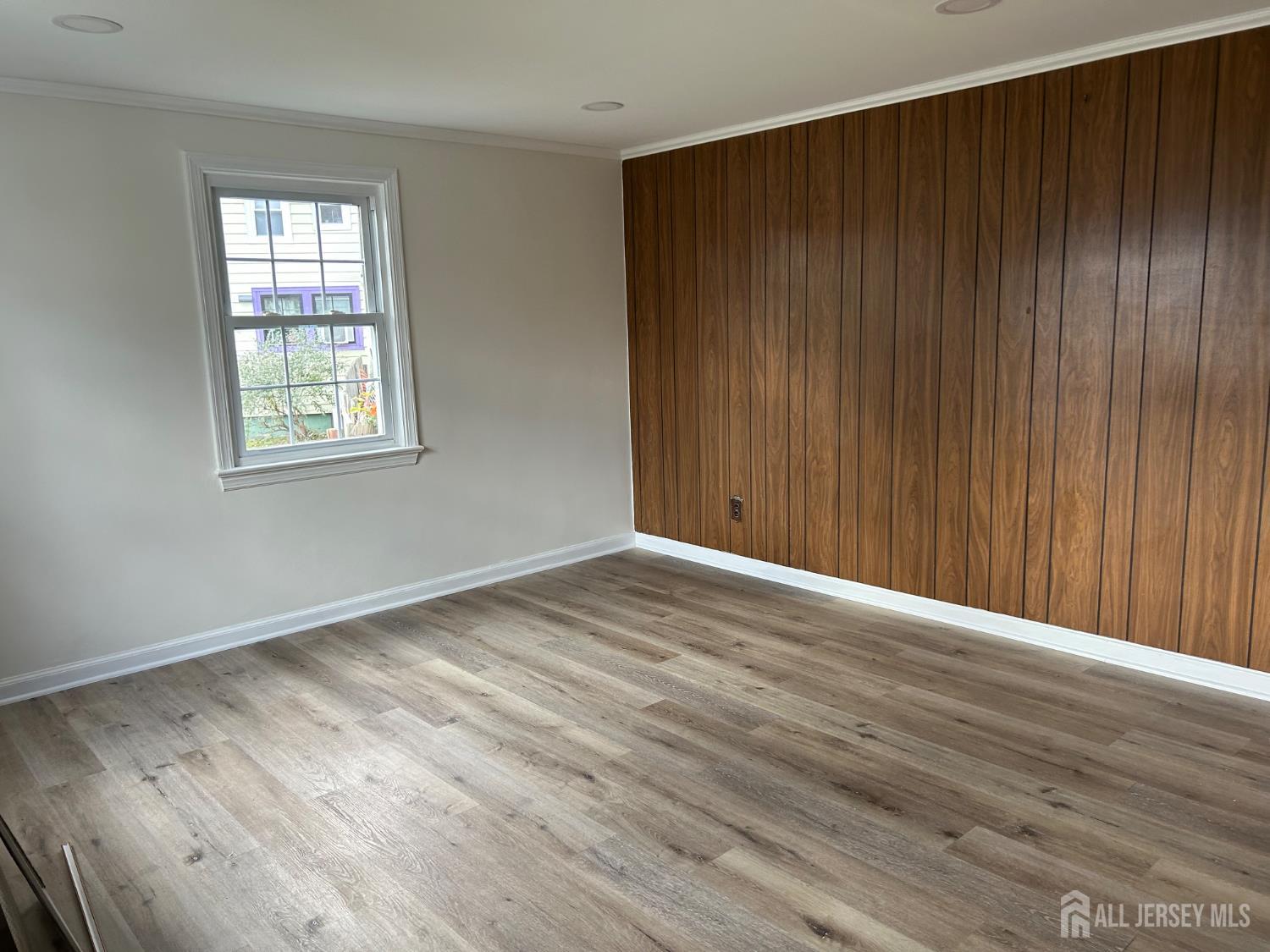 518 2nd Street Dunellen, NJ 08812 - Photo 3 of 14 an empty room with wooden floor and windows