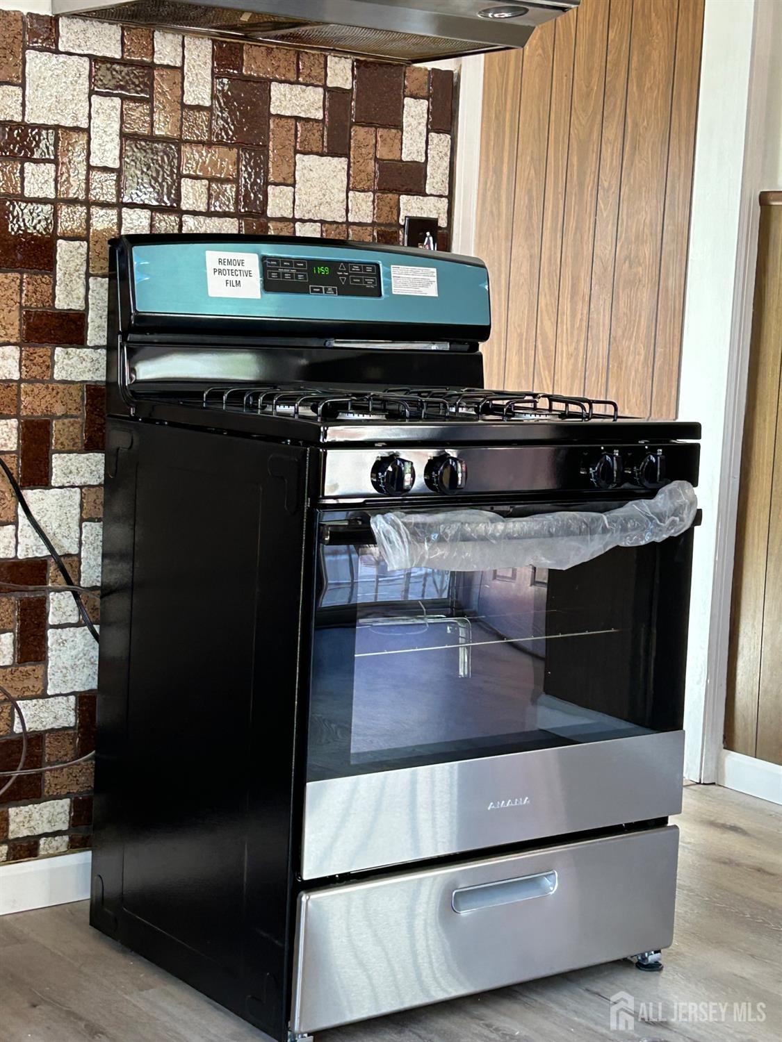 518 2nd Street Dunellen, NJ 08812 - Photo 6 of 14 a kitchen with a stove and a microwave