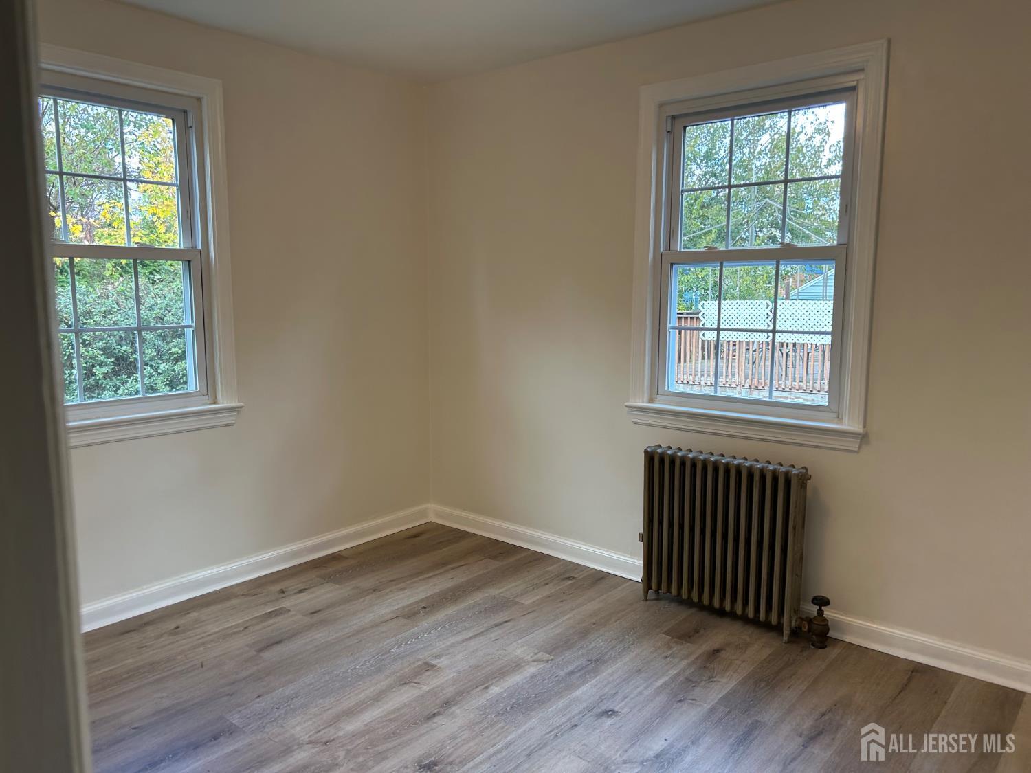 518 2nd Street Dunellen, NJ 08812 - Photo 7 of 14 an empty room with wooden floor and windows