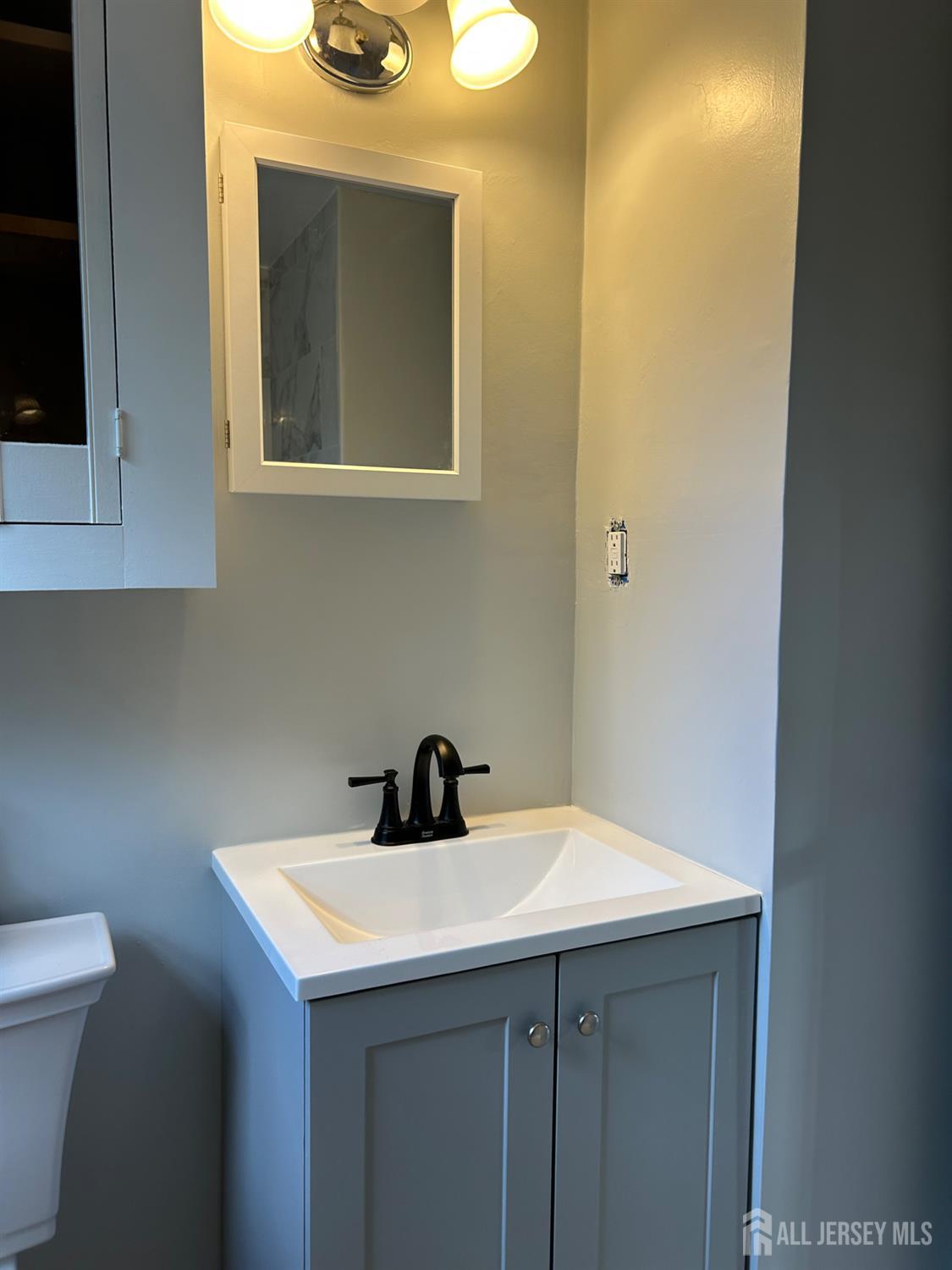 518 2nd Street Dunellen, NJ 08812 - Photo 8 of 14 a bathroom with a sink and a toilet