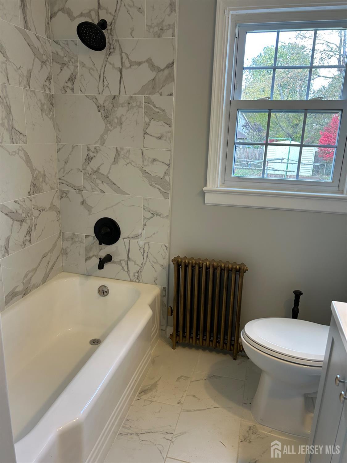 518 2nd Street Dunellen, NJ 08812 - Photo 9 of 14 a bathroom with a bathtub and a toilet