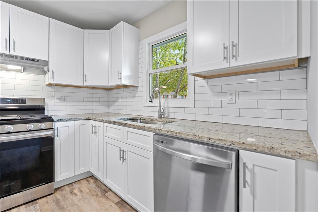 33 Smyrna Powder Springs Road Southeast Marietta, GA 30060 - Photo 11 of 37 a kitchen with stainless steel appliances granite countertop a sink stove and cabinets