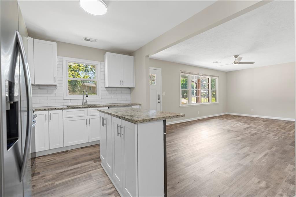 33 Smyrna Powder Springs Road Southeast Marietta, GA 30060 - Photo 13 of 37 a kitchen with granite countertop a refrigerator sink and cabinets