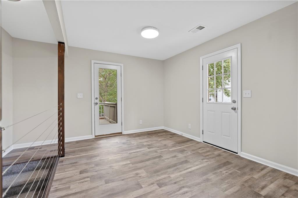33 Smyrna Powder Springs Road Southeast Marietta, GA 30060 - Photo 14 of 37 an empty room with wooden floor and windows
