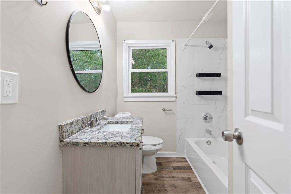 33 Smyrna Powder Springs Road Southeast Marietta, GA 30060 - Photo 19 of 37 a bathroom with a granite countertop sink a toilet and a bathtub