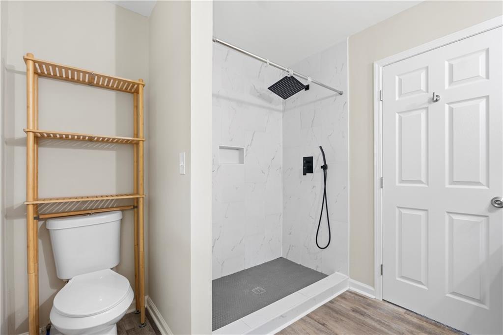 33 Smyrna Powder Springs Road Southeast Marietta, GA 30060 - Photo 22 of 37 a bathroom with a granite countertop shower and a toilet