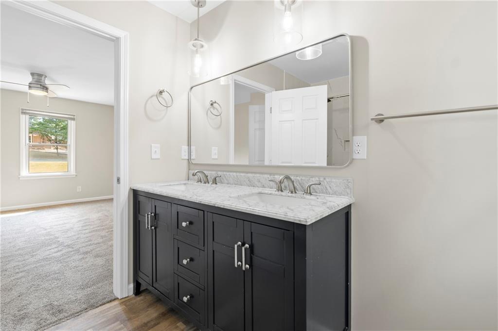 33 Smyrna Powder Springs Road Southeast Marietta, GA 30060 - Photo 23 of 37 a bathroom with a granite countertop sink two mirror and a