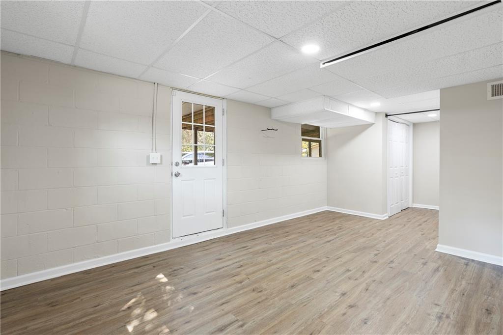 33 Smyrna Powder Springs Road Southeast Marietta, GA 30060 - Photo 29 of 37 an empty room with wooden floor and windows
