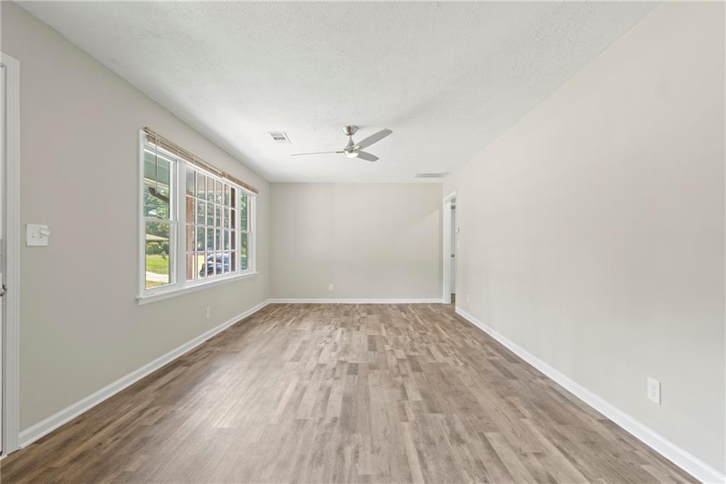 33 Smyrna Powder Springs Road Southeast Marietta, GA 30060 - Photo 6 of 37 a view of an empty room with a window and wooden floor
