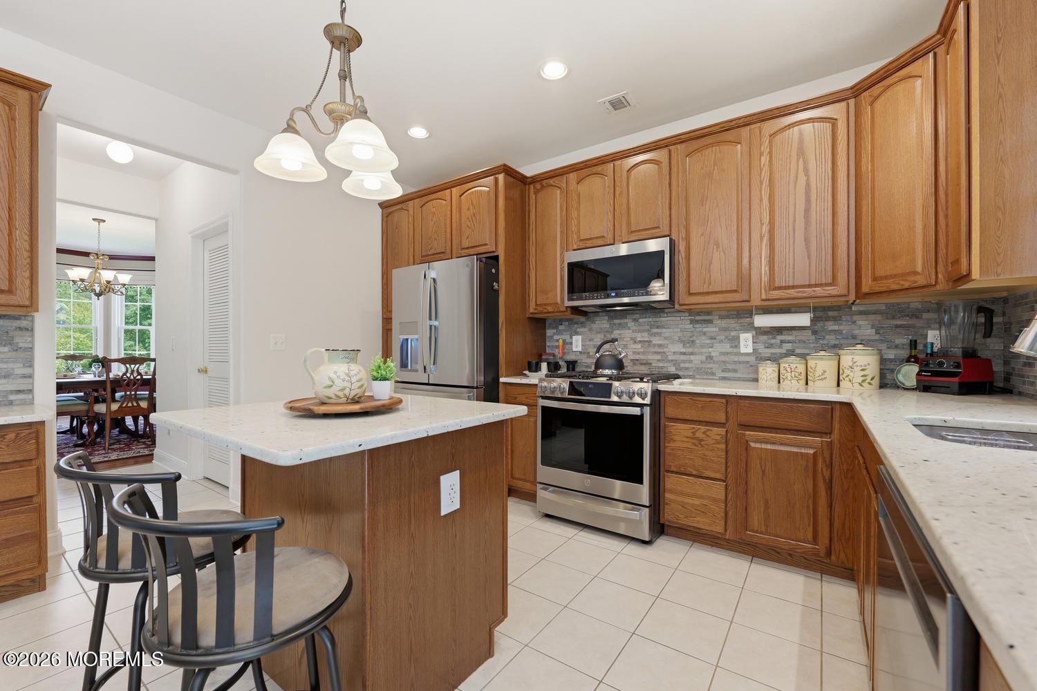7 Cherry Tree Lane Cream Ridge, NJ 08514 - Photo 11 of 47 a kitchen with stainless steel appliances granite countertop a stove refrigerator sink and cabinets