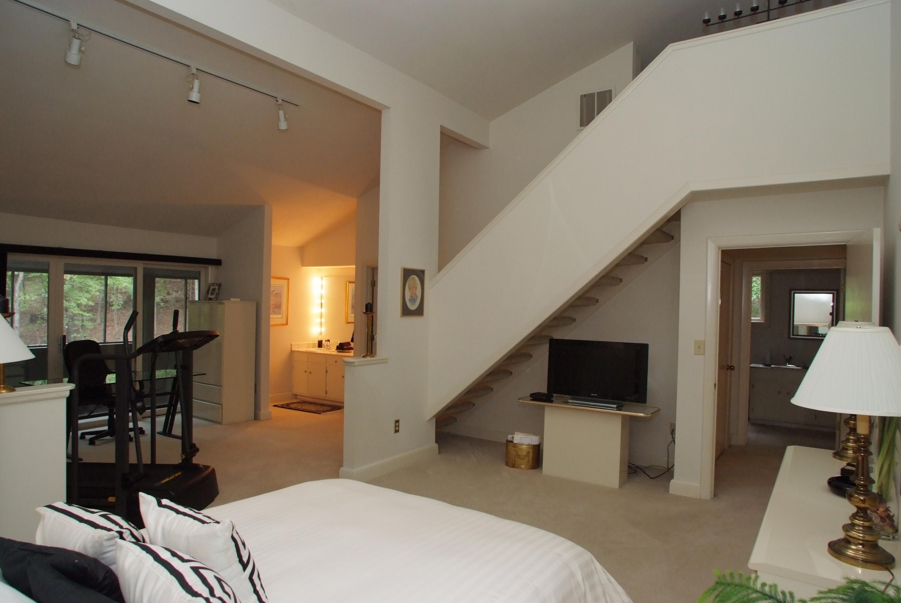 4838 Deerfield Road Southwest Roanoke, VA 24018 - Photo 19 of 26 a bedroom with a bed and large windows