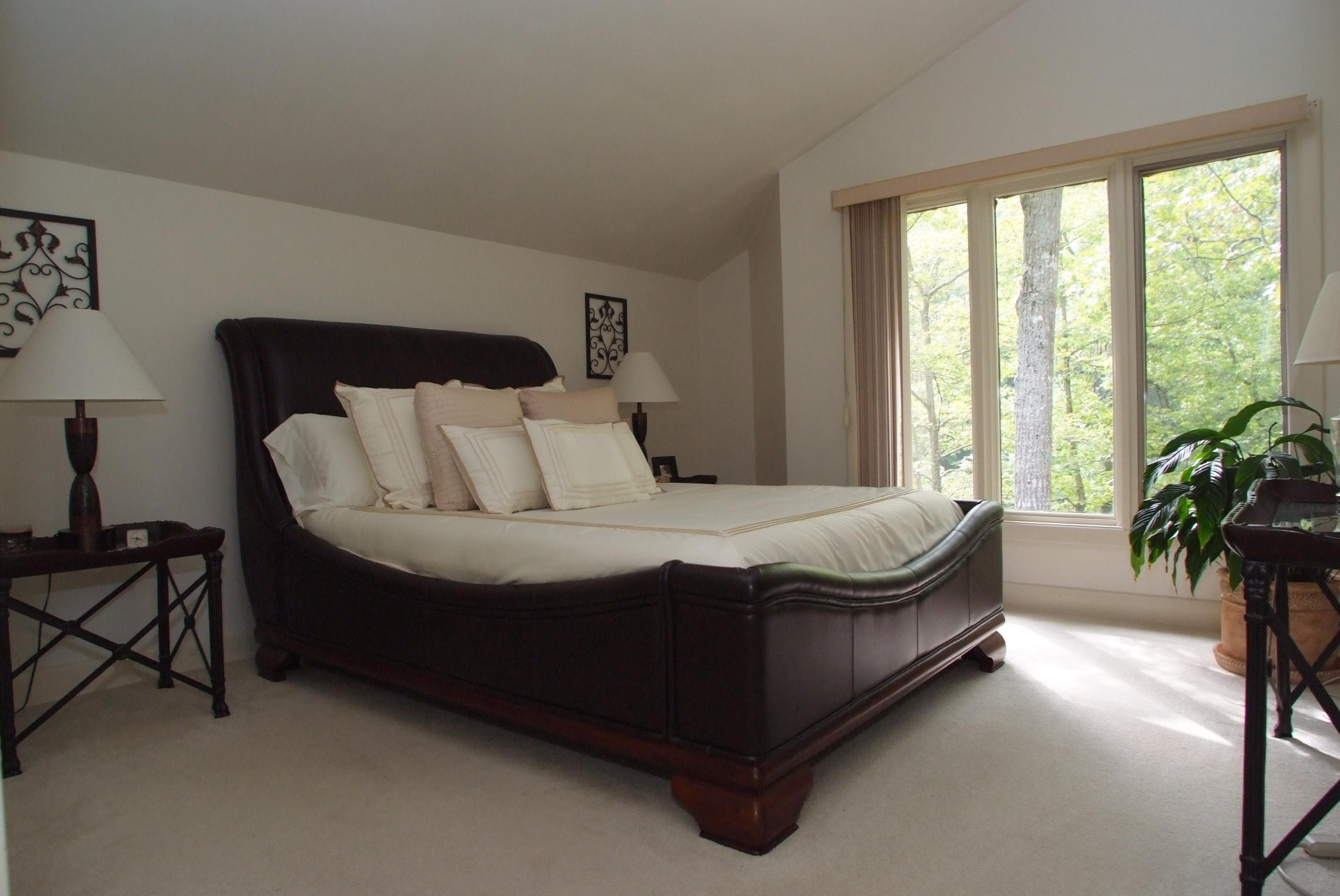 4838 Deerfield Road Southwest Roanoke, VA 24018 - Photo 21 of 26 a spacious bedroom with a bed and a potted plant