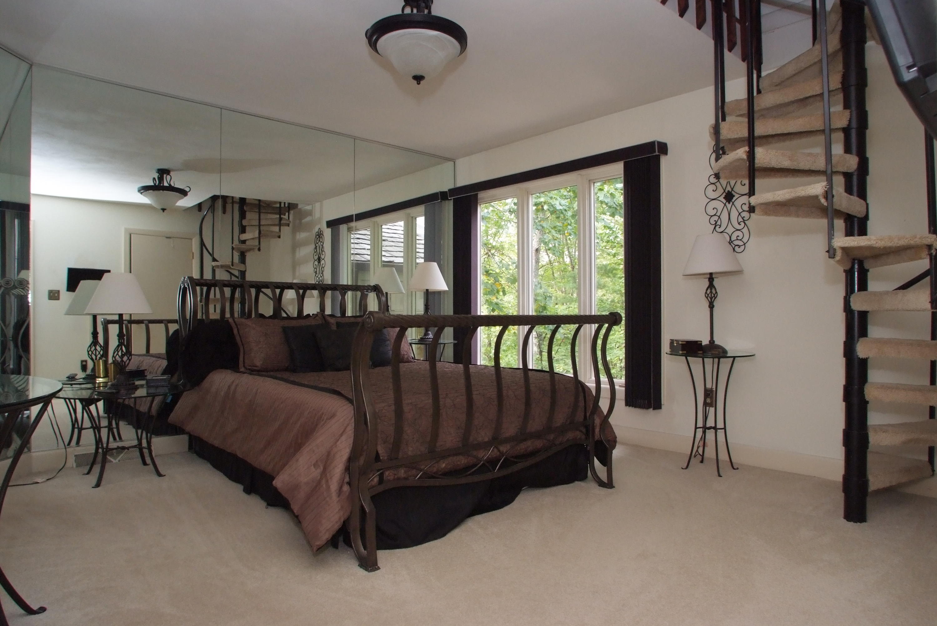 4838 Deerfield Road Southwest Roanoke, VA 24018 - Photo 22 of 26 a bed sitting in a bedroom next to a window