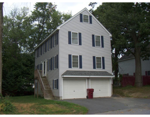 57 Magnolia Street Lowell, MA 01854 - Photo 1 of 1 a view of a white house with large windows and yard