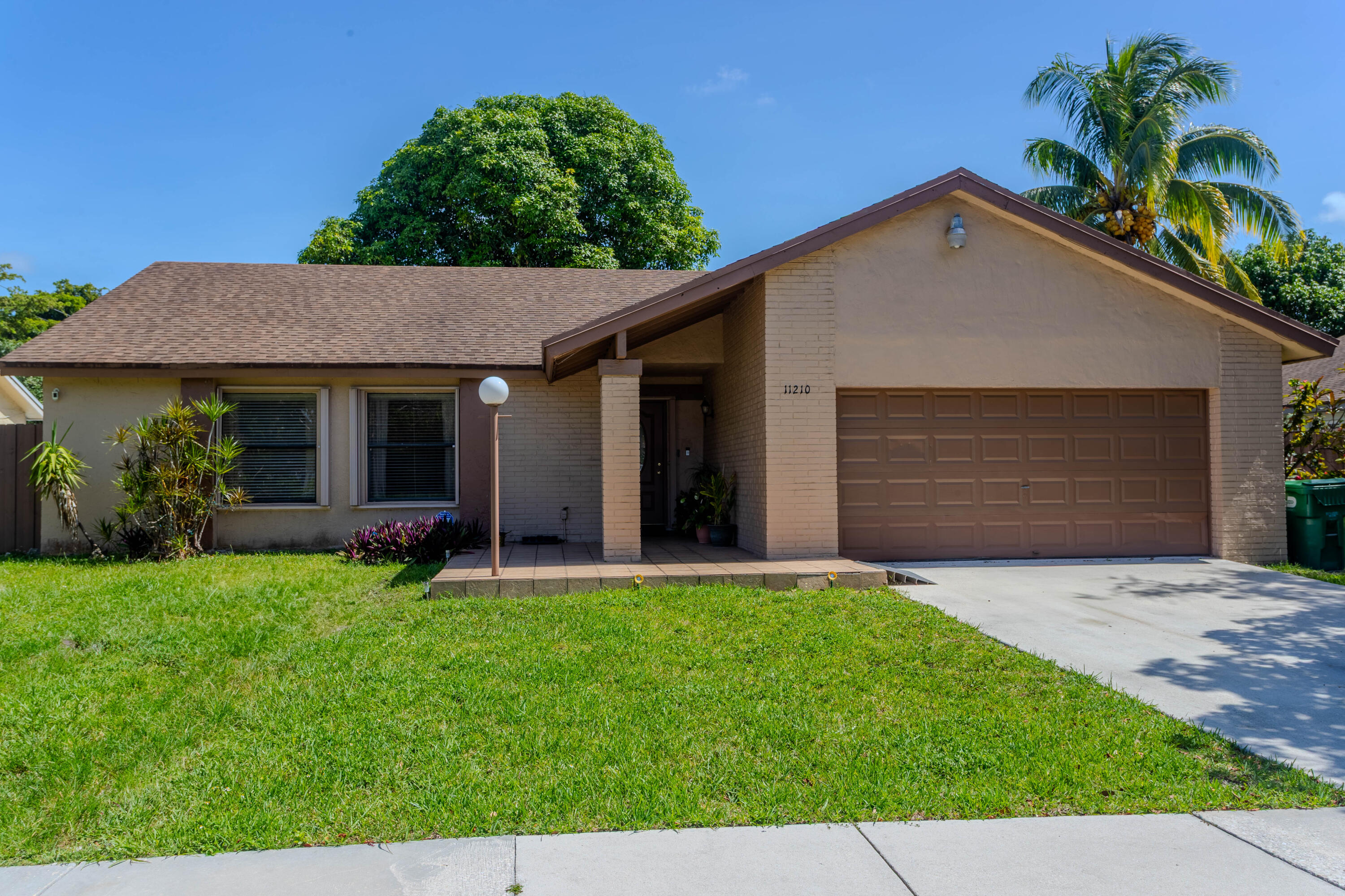 11210 Southwest 157th Street Miami, FL 33157 - Photo 1 of 55 a front view of a house with a yard