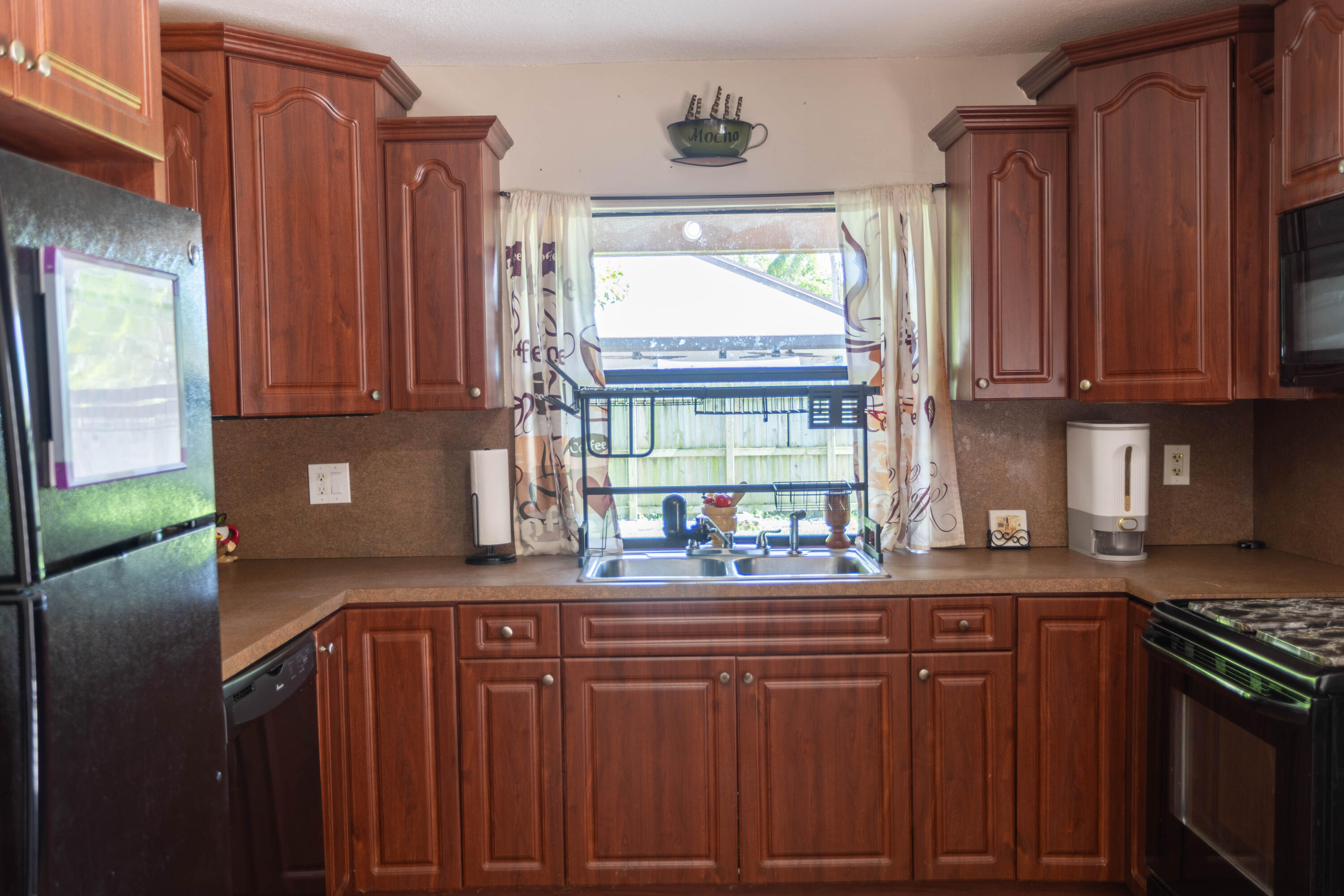 11210 Southwest 157th Street Miami, FL 33157 - Photo 11 of 55 a kitchen with stainless steel appliances granite countertop a stove a sink and a microwave