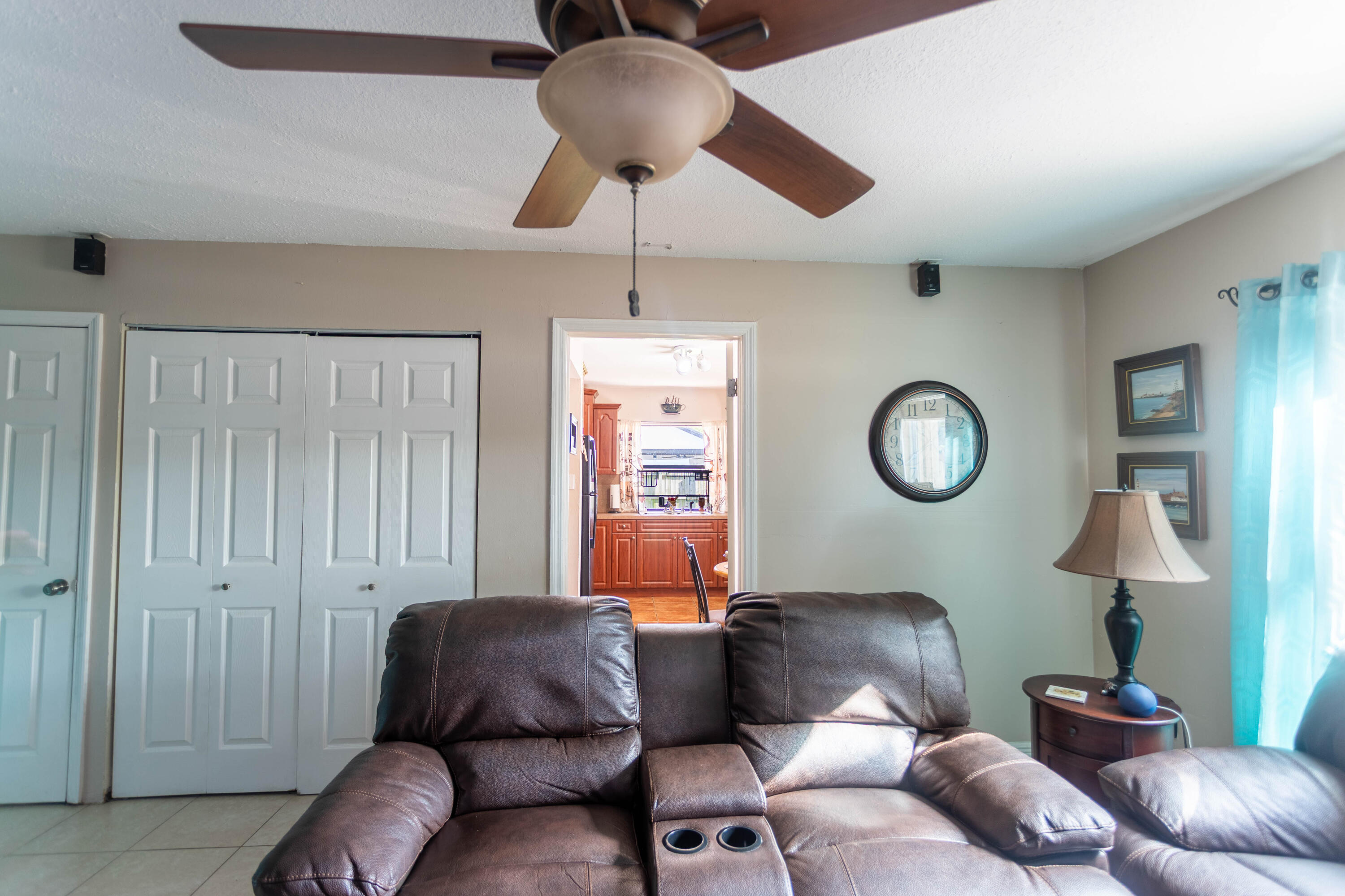 11210 Southwest 157th Street Miami, FL 33157 - Photo 16 of 55 a living room with furniture a chandelier fan and a window