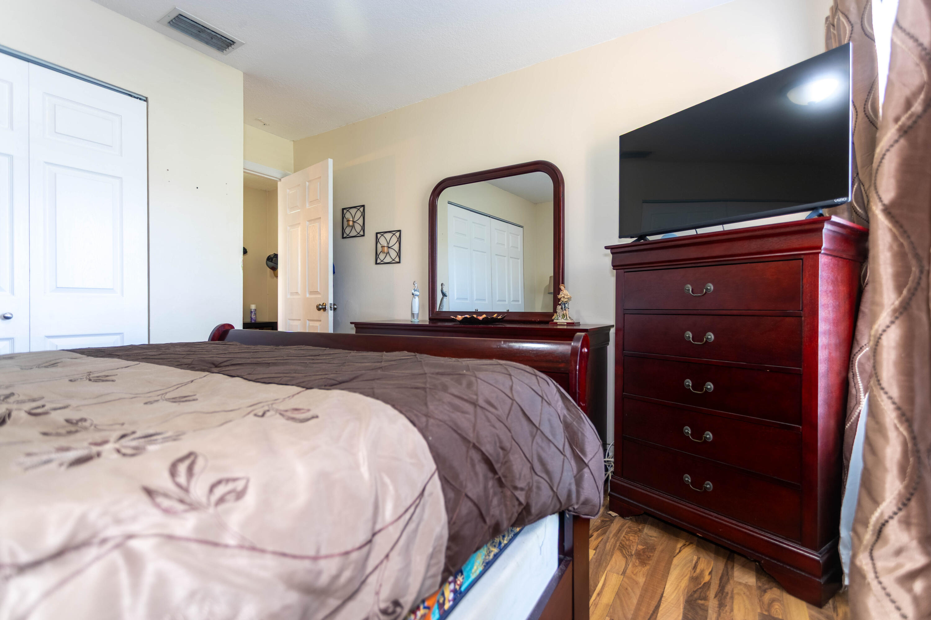 11210 Southwest 157th Street Miami, FL 33157 - Photo 30 of 55 a bedroom with a bed and a flat screen tv