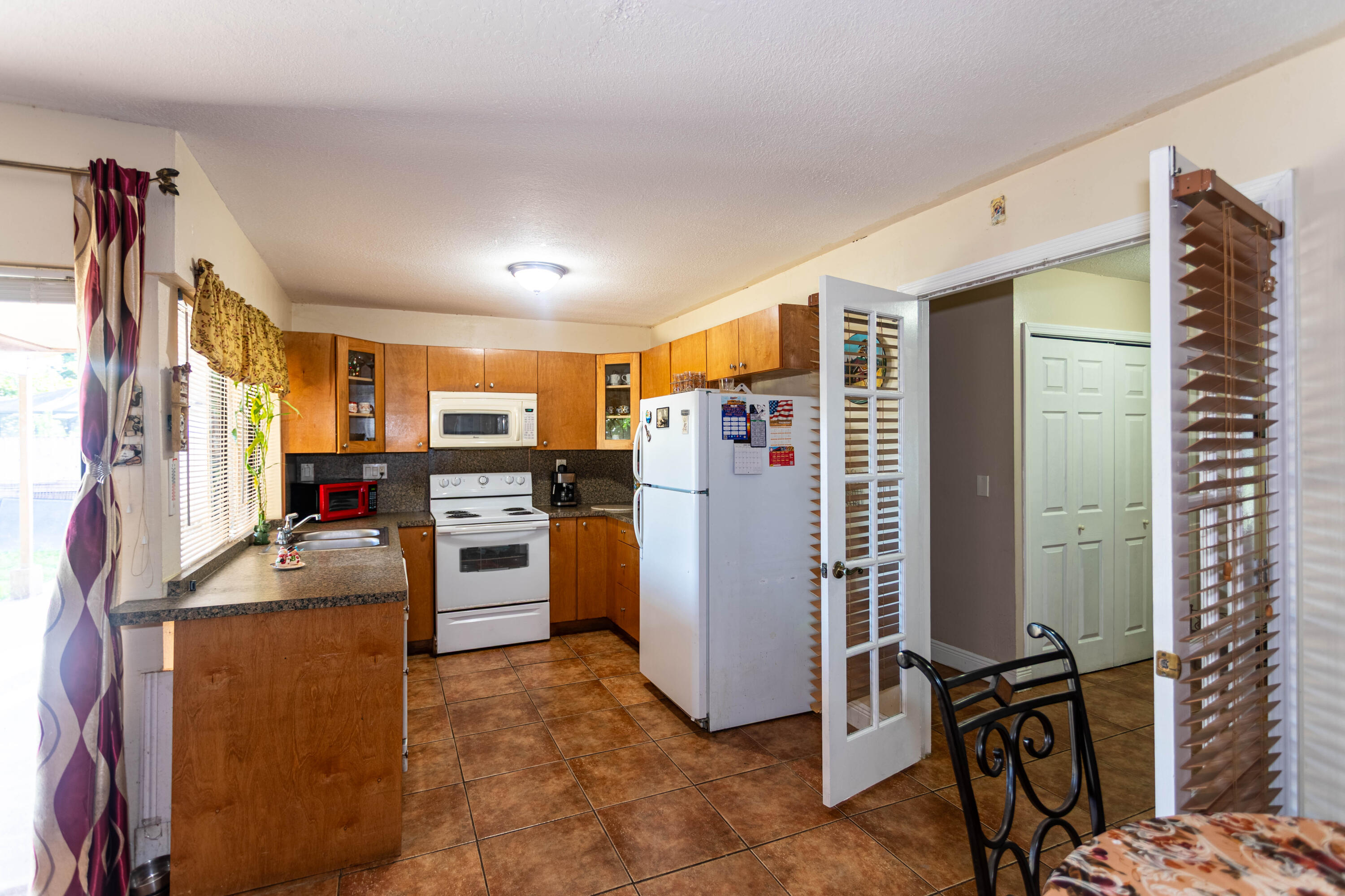 11210 Southwest 157th Street Miami, FL 33157 - Photo 34 of 55 a kitchen with refrigerator and microwave