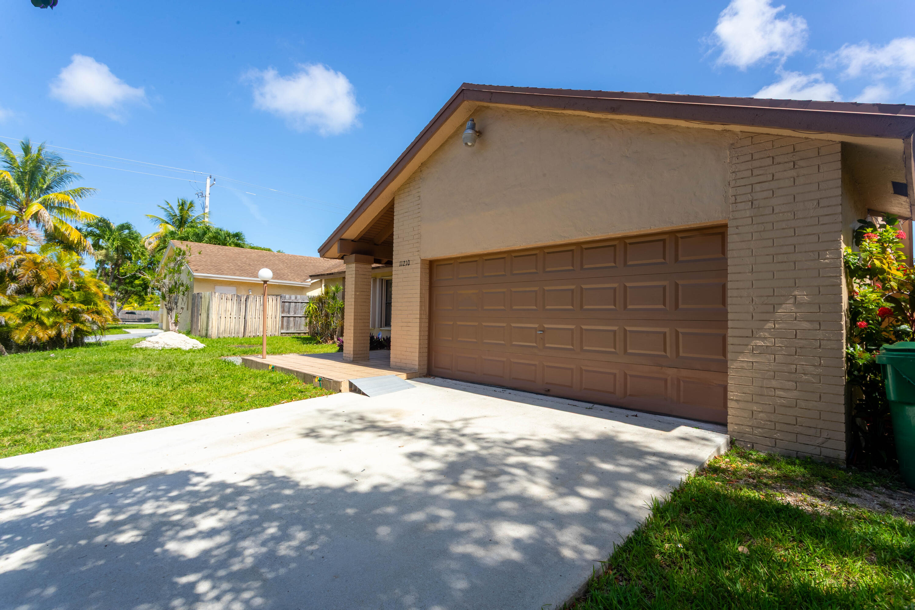 11210 Southwest 157th Street Miami, FL 33157 - Photo 4 of 55 a front view of a house with a yard