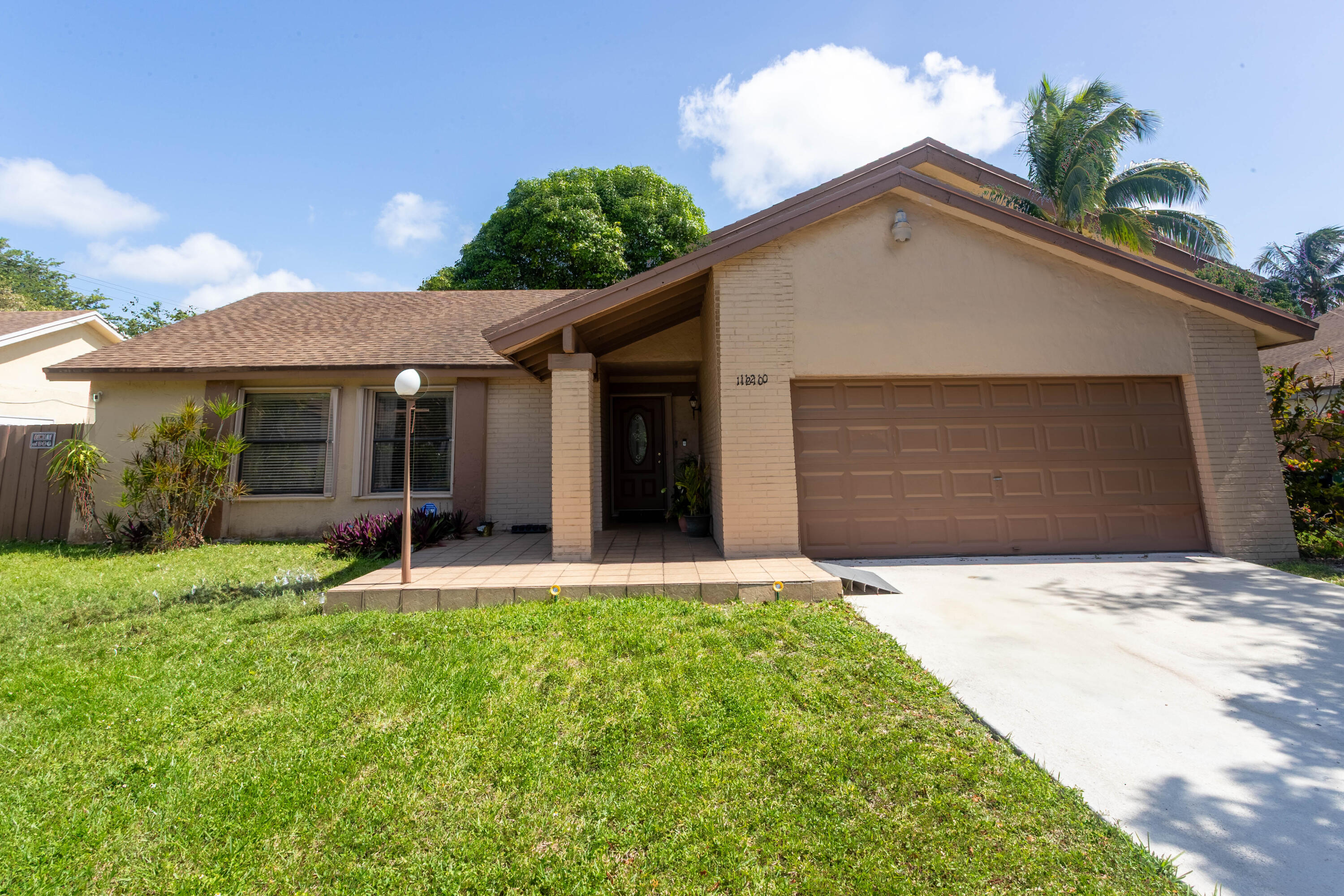 11210 Southwest 157th Street Miami, FL 33157 - Photo 7 of 55 a front view of a house with a yard and garage