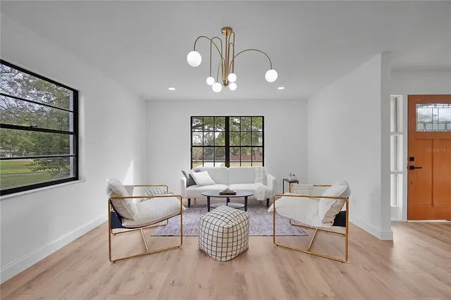a view of a dining room with furniture and chandelier