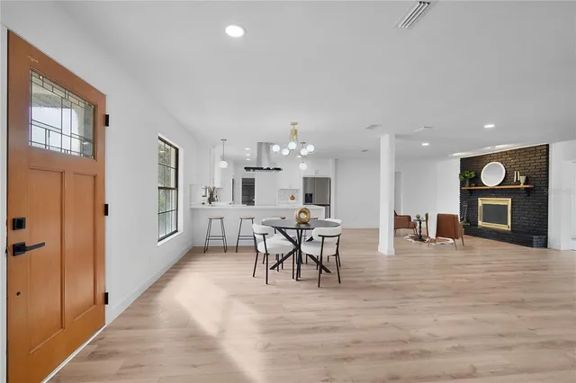 a kitchen with white cabinets and refrigerator